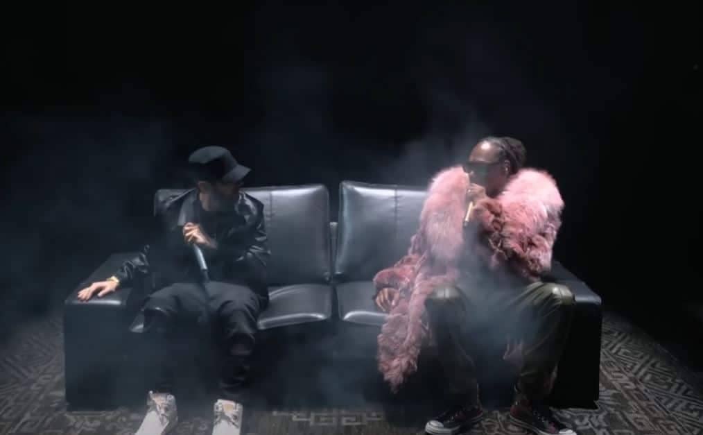 Image of Snoop Dogg and Eminem sitting together on a black couch during the MTV VMAs