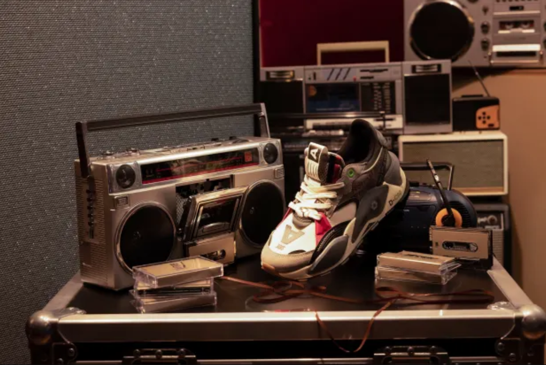 image of PUMA x Roc Nation sneakers near a record player